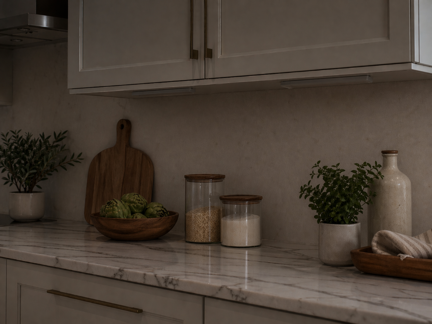 Before and after kitchen view showing NestLuma under-cabinet motion light adding warm illumination